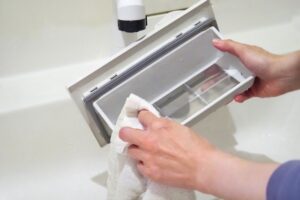 エアータオルの清掃箇所を確認しながら点検するスタッフ<img loading=